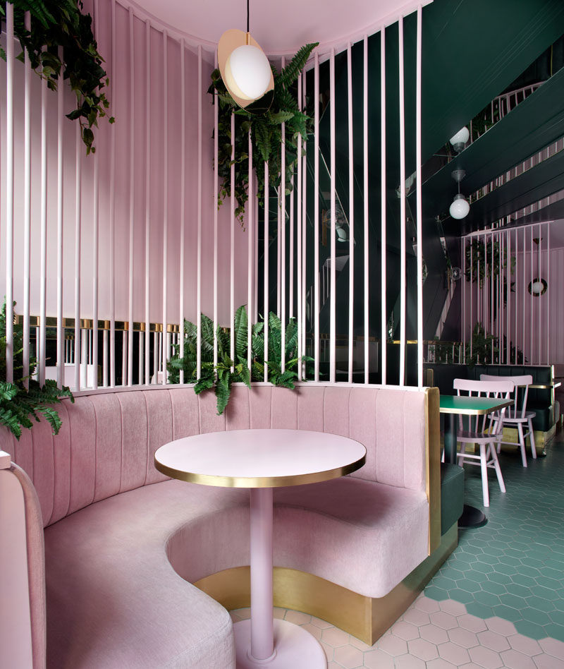 This modern cafe has open velvet caged booths that creating a separation between the different seating areas. #ModernCafe #CafeDesign #InteriorDesign