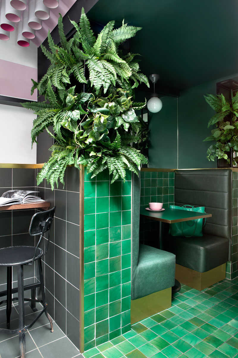 This modern cafe uses a variety of materials in pink, green and grey, to create a unique experience. #CafeInterior #CafeDesgin #GreenTile