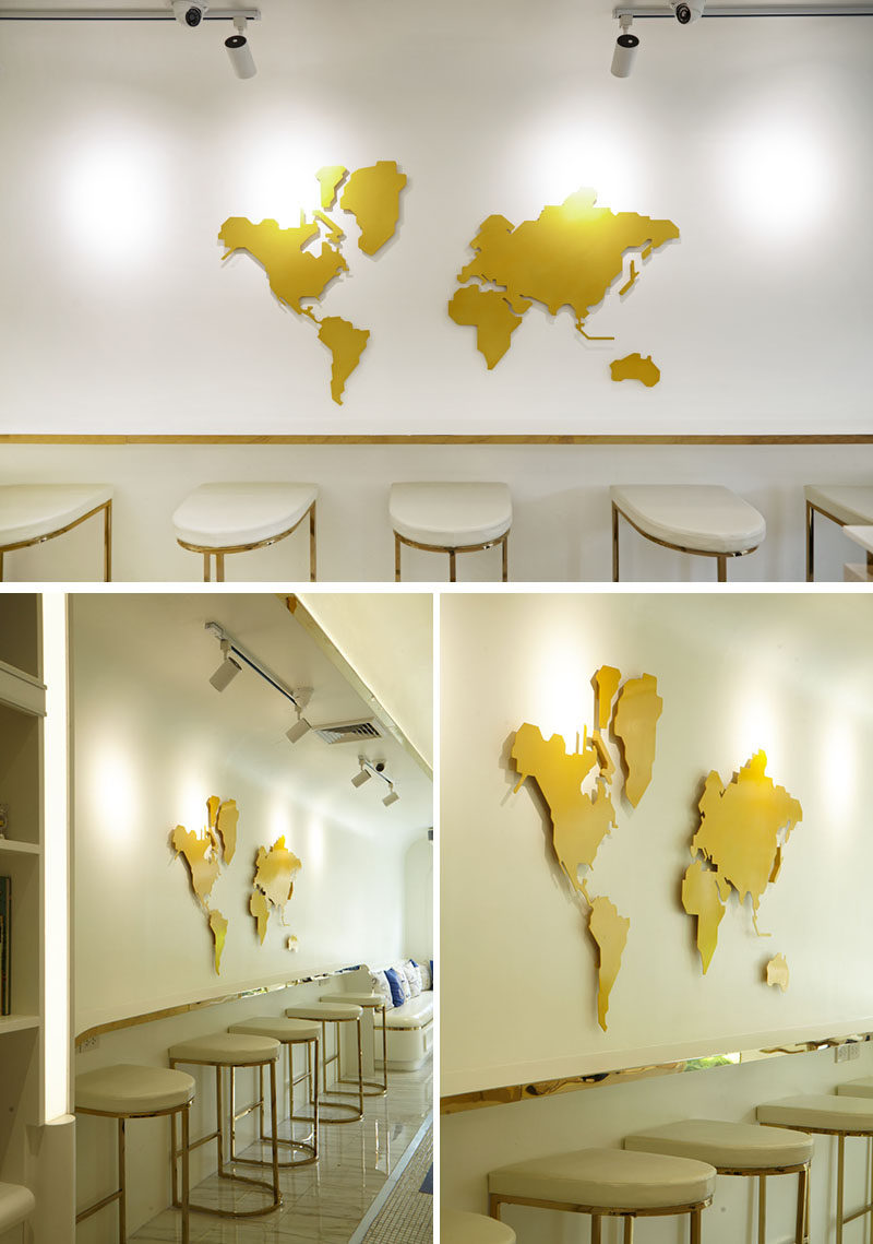 This modern gelato boutique features a world map on the wall above a row of bar seats. #WorldMap #RetailDesign #Cafe