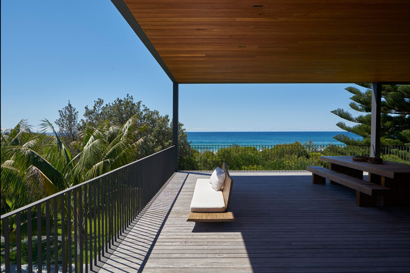 This modern house has a large covered deck for entertaining and to take advantage of the water views. #Deck #CoveredDeck #ModernHouse