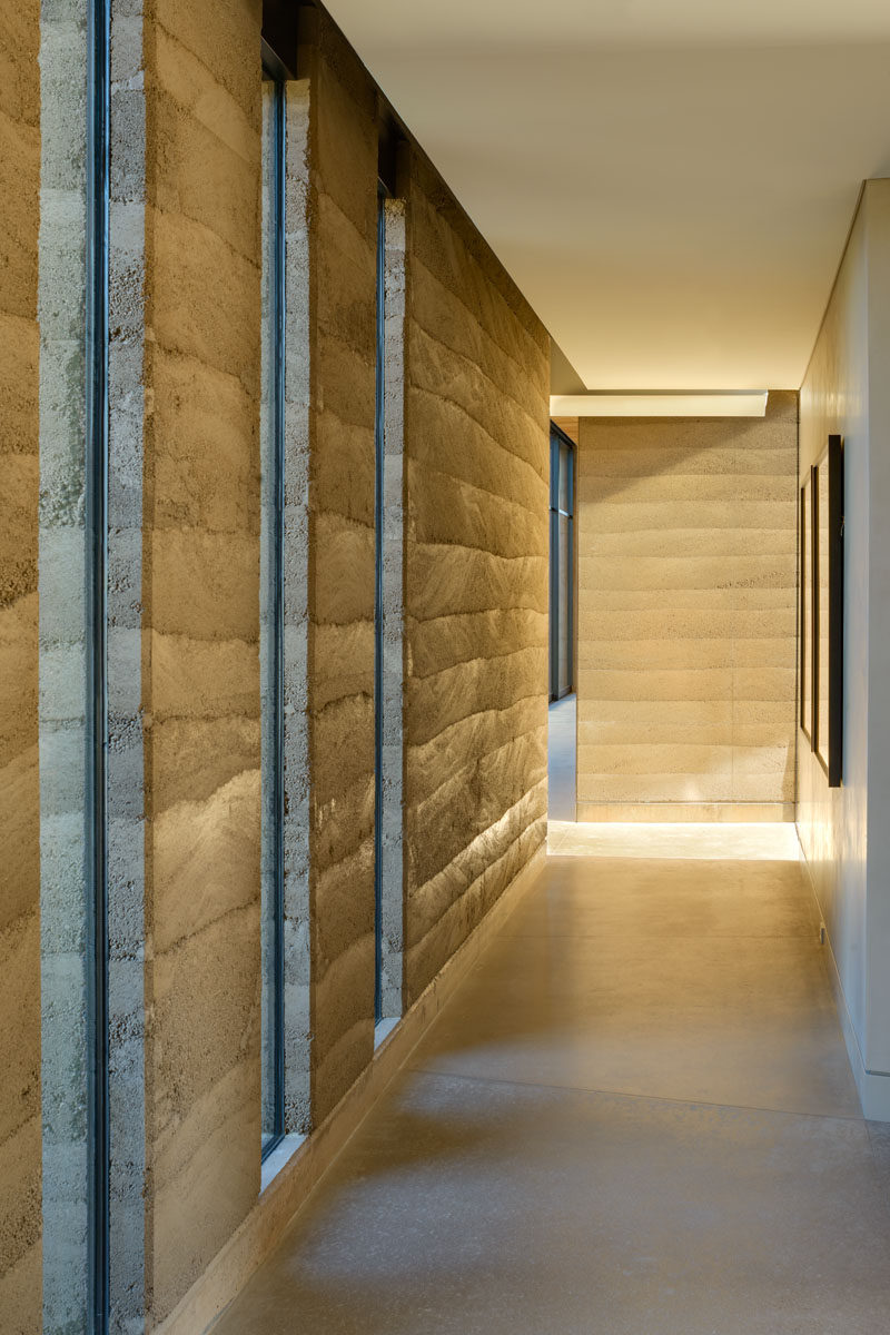 The rammed earth walls add a natural element to his modern home, with the clearly defined layers creating a subtle artistic quality. #RammedEarthWalls #RammedEarth #Architecture