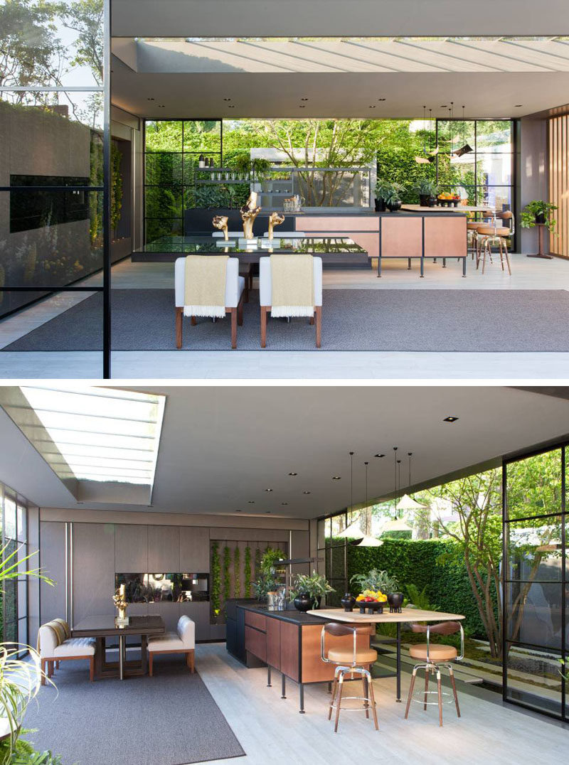 This modern garden pavilion with glass walls features a dining area and kitchen with a living wall. #GardenPavilion #InteriorDesign #LandscapeDesign