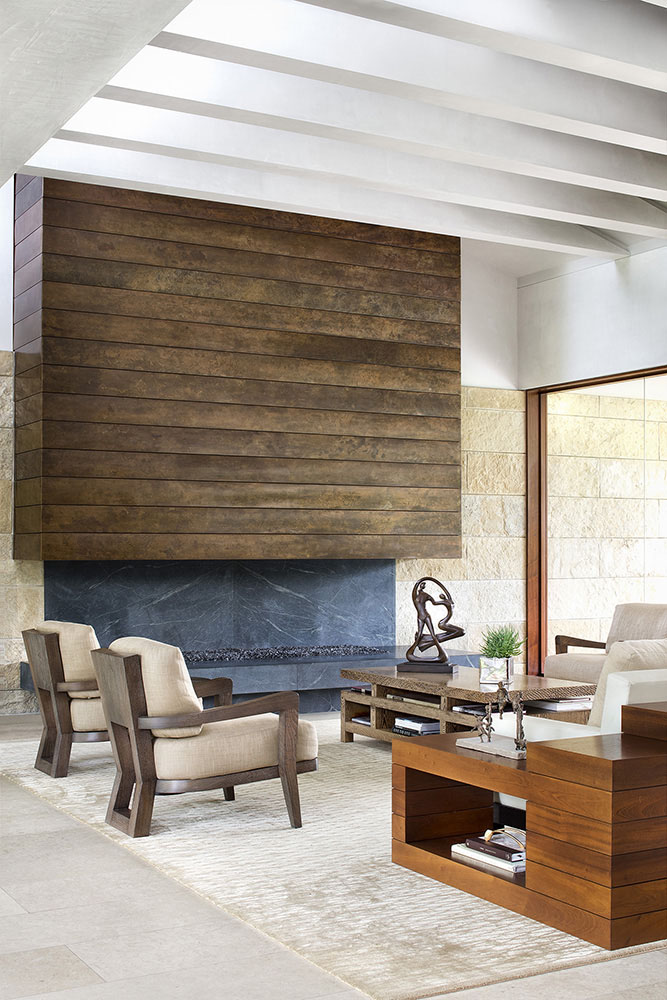 In this contemporary living room, an eye-catching fireplace has been created using weathering steel and Old Dominion soapstone. #FireplaceDesign #Fireplace #InteriorDesign #LivingRoom