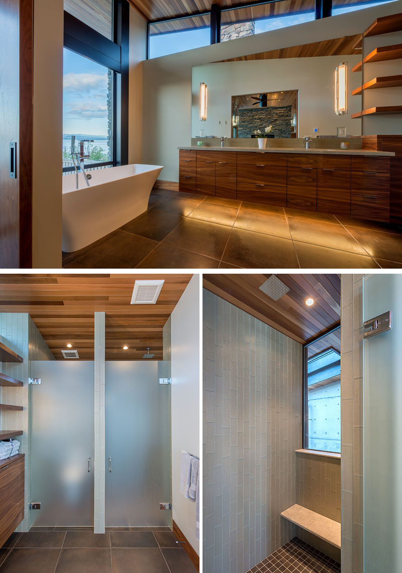 This modern master bathroom has a soaking tub positioned in front of the window to take advantage of the water view. On the wall opposite the bath tub a toilet and shower, both with opaque doors. #BathroomDesign #ModernBathroom