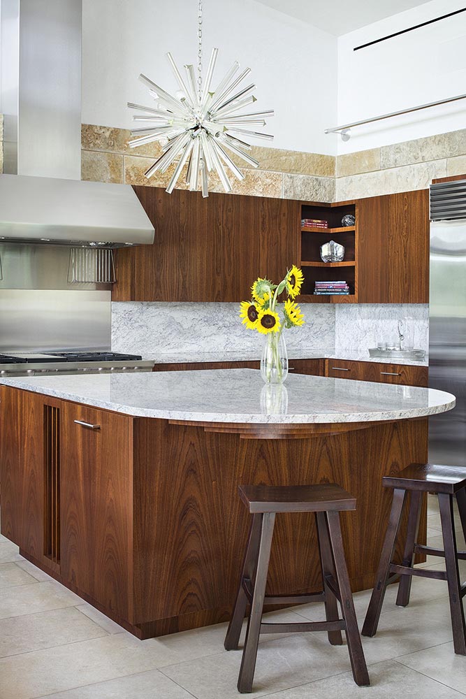 In this contemporary kitchen, custom designed wood kitchen cabinetry is topped with a marble countertop. #KitchenDesign #WoodKitchen #InteriorDesign