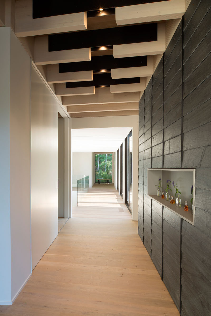 This hallway shows off the steel flitch plates used to connect the beams in the construction of this modern house. #Architecture #Hallway #Beams