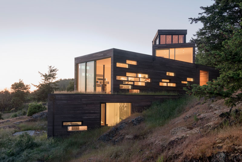 Architecture firm Prentiss + Balance + Wickline, have designed a multi-level, modern wood house in Friday Harbor, Washington State, that's anchored into the rocky slope. #ModernHouse #ModernArchitecture