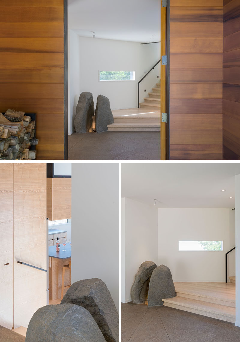 This modern house has a feature stone element, and wood stairs that connect the various boxes of the home. #StoneFeature #InteriorDesign