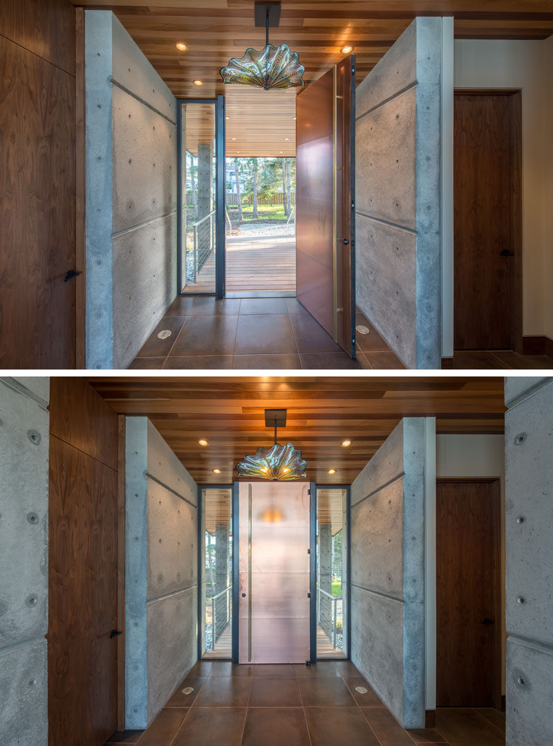 A tall metallic front door welcomes visitors to this beachfront studio. #FrontDoor #InteriorDesign