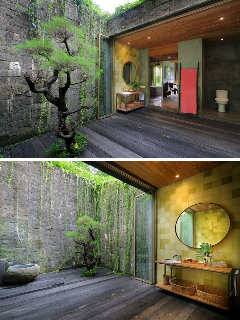 This bathroom opens up to a private courtyard with stone walls and a tree. #Bathroom #Courtyard #PrivateCourtyard