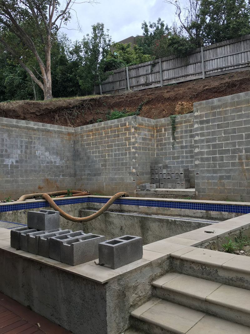 Before & After - the before - this pool area was transformed into a modern and relaxing oasis with a outdoor lounge and built-in planters. #BeforePic #SwimmingPool