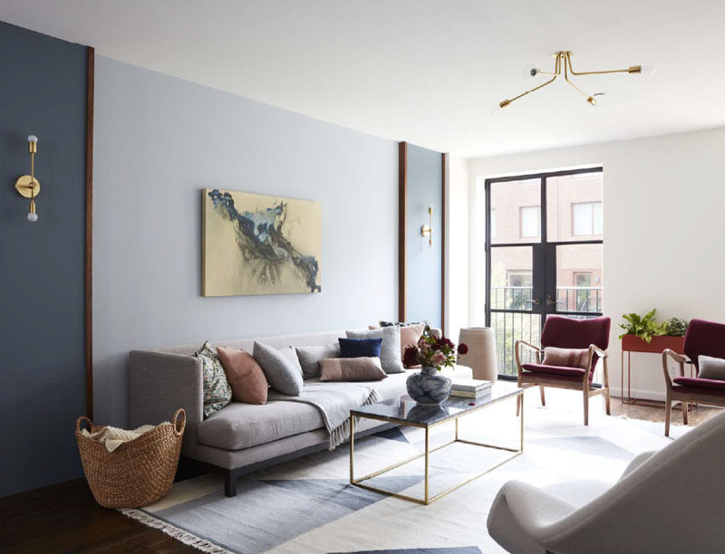 This contemporary living room has steel and glass French doors that open up to a Juliet balcony. #LivingRoom #Sconces #ContemporaryLivingRoom