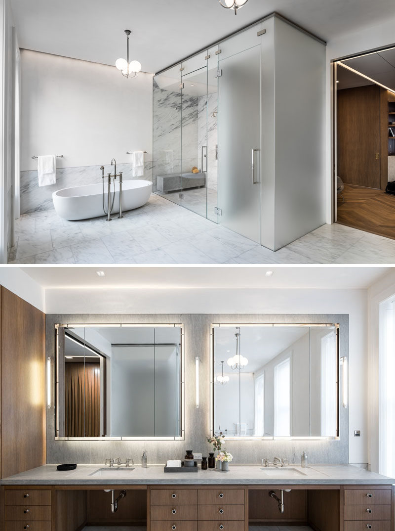 This modern master bath is clad in imperial Danby marble and white Venetian plaster. Clear glass surrounds the shower, while opaque glass houses the toilet. #ModernBathroom #MasterBathroom #Marble #Vanity