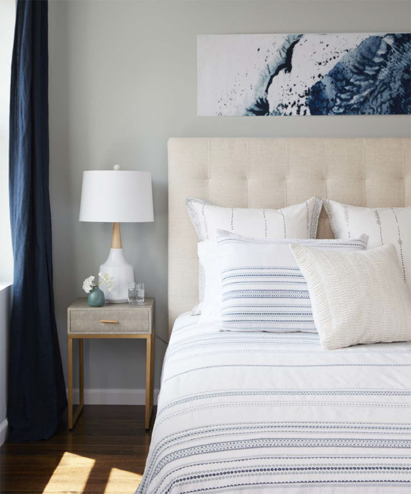 In this contemporary master bedroom, neutral tones with dark blue accents have been used to create a relaxing atmosphere. #MasterBedroom #BedroomDesign #NeutralBedroom