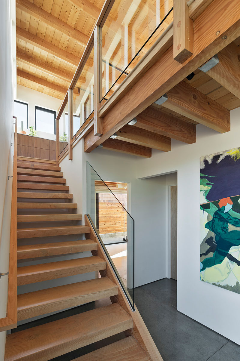 Wood open tread stairs in this modern house lead to the living spaces on the top floor. #Stairs #WoodStairs #OpenTreadStairs