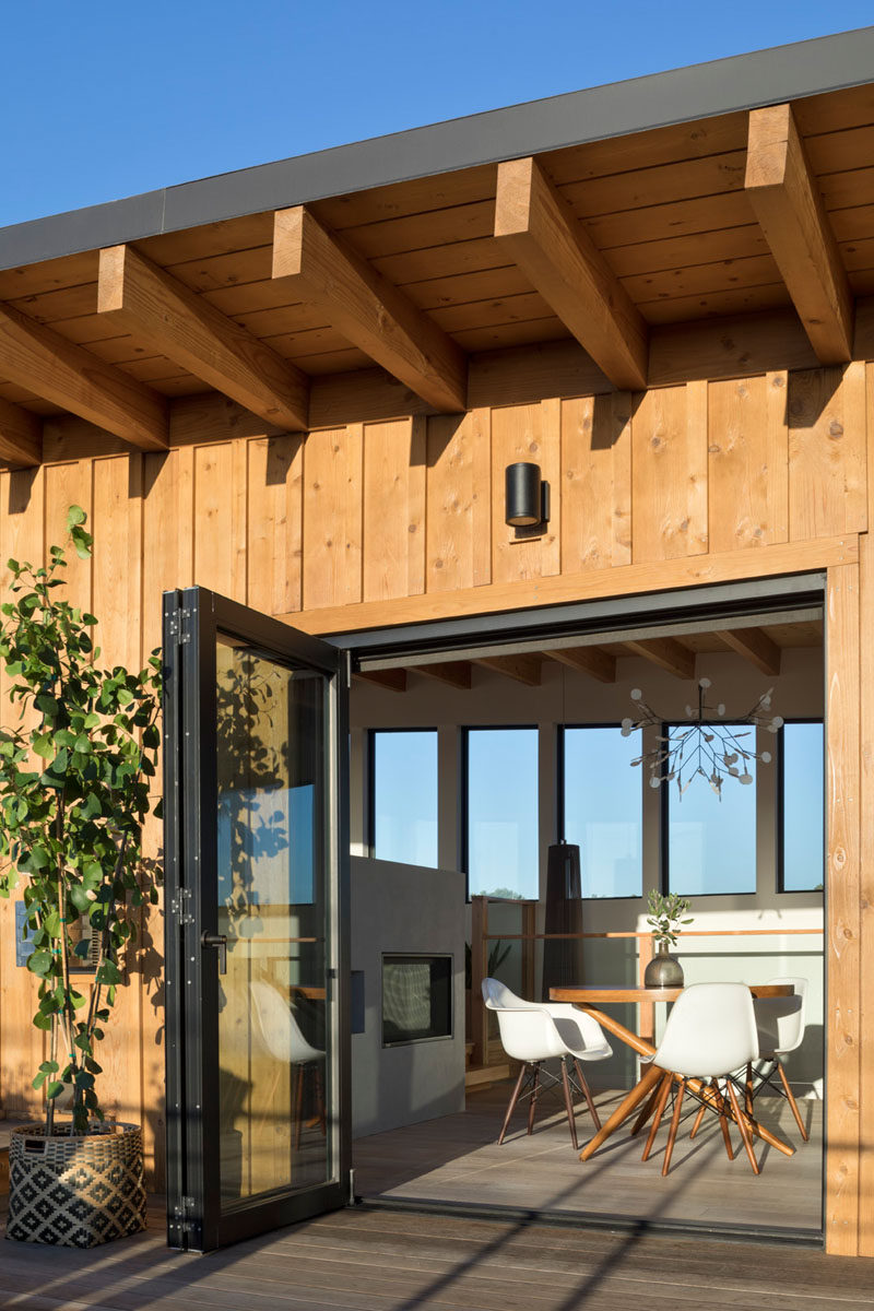 Bi-folding doors face onto the view deck from the dining area in order to maximize the connection to the outdoors. #Deck #Architecture #Doors