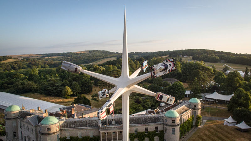 Artist Gerry Judah has designed the 2018 Goodwood Festival Of Speed sculpture that stands 52m high and has six arms that hold an iconic Porsche road or race car. #Sculpture #Art #Cars