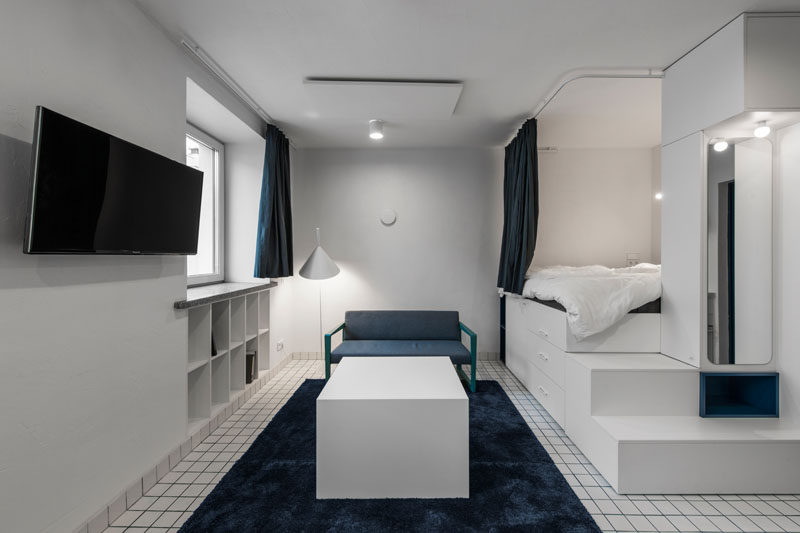 This modern micro apartment has a lofted bed with storage underneath, a living area, kitchenette, and bathroom. #MicroApartment #StudioApartment #LoftBed #BedWithStorage #SmallApartment #BlueGrout