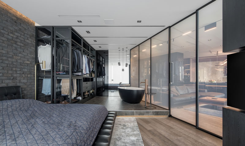 This modern bedroom features a 'smart glass' wall that transforms from transparent to opaque, and a movable wardrobe that expands to allow access to all of the clothes. #SmartGlass #GlassWall #InteriorDesign