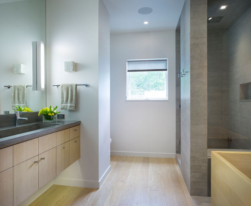 In this contemporary bathroom, the materials have been kept simple, and a hidden lights have been under the floating vanity. #BathroomDesign