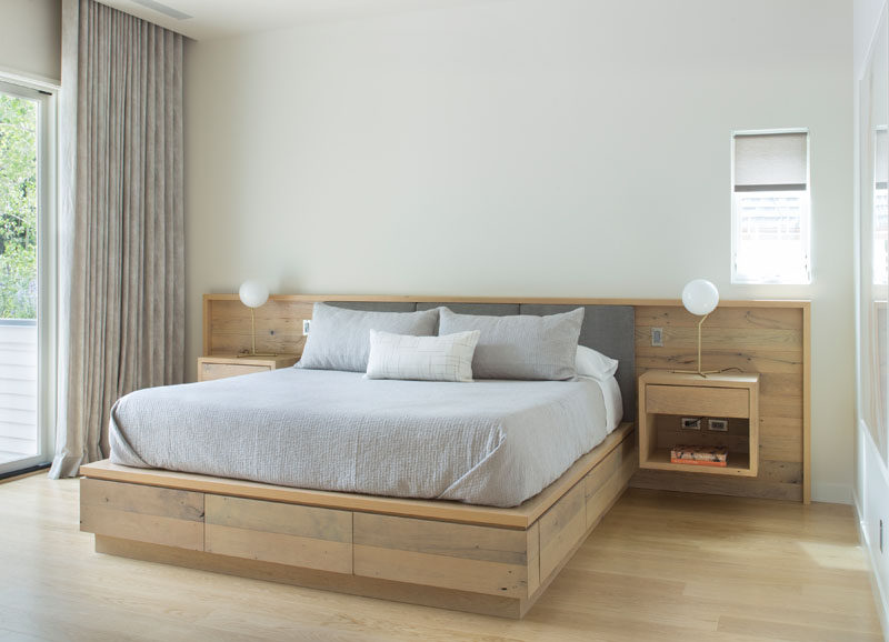 This contemporary bedroom features a custom designed built-in wood bed frame with floating bedside tables. #Bedroom #Bedframe #WoodBedframe #BedroomDesign