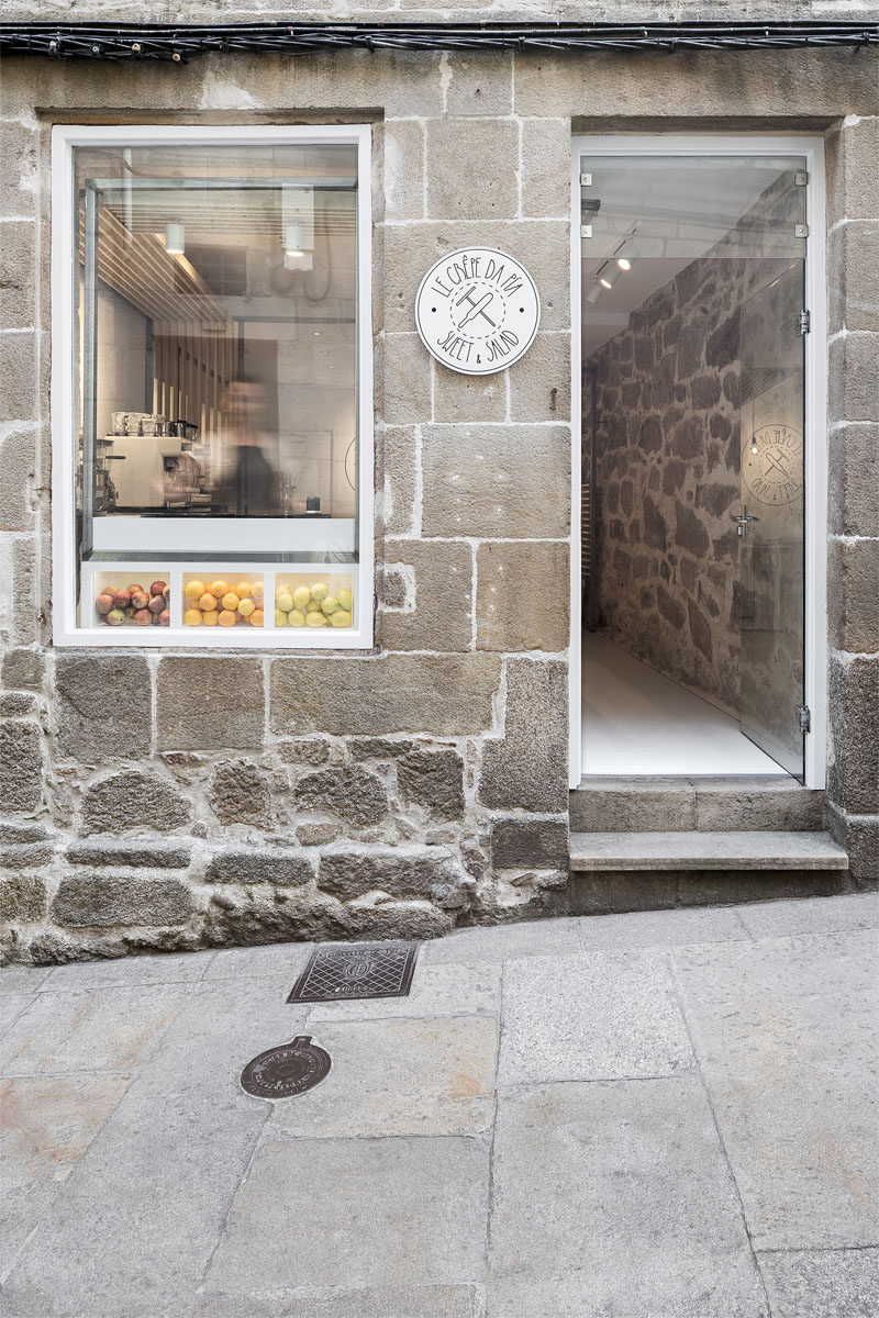 Erbalunga estudio have designed a creperie in Spain that combines original old stone, and new modern design elements. #Creperie #Cafe #RetailDesign #WoodSlats