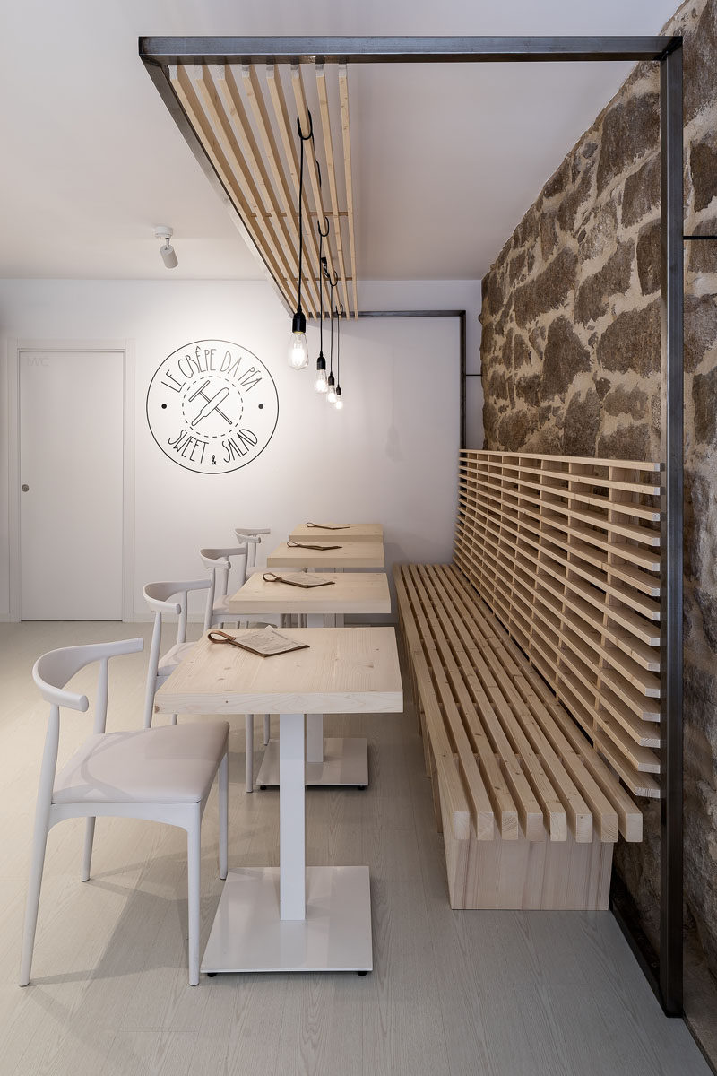 Erbalunga estudio have designed a creperie in Spain that combines original old stone, and new modern design elements. #Creperie #Cafe #RetailDesign #WoodSlats