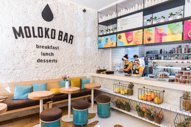 JK Lab Architects have designed Moloko Bar, a small cafe in Odessa, Ukraine, that combines blues and yellow with natural materials and a couple of fun design elements. #CafeDesign #InteriorDesign