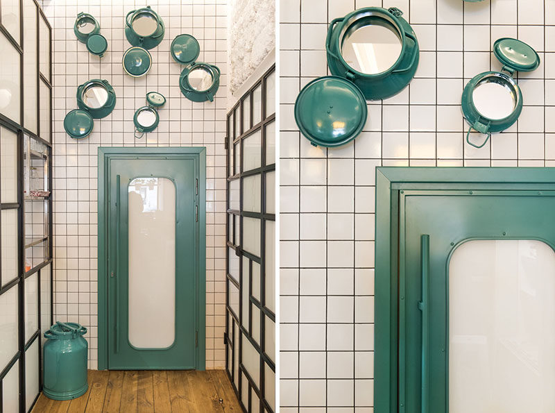 This modern cafe uses painted portholes with mirrors inside them as a decorative element. #CafeDesign #DesignAccent #WallDecor