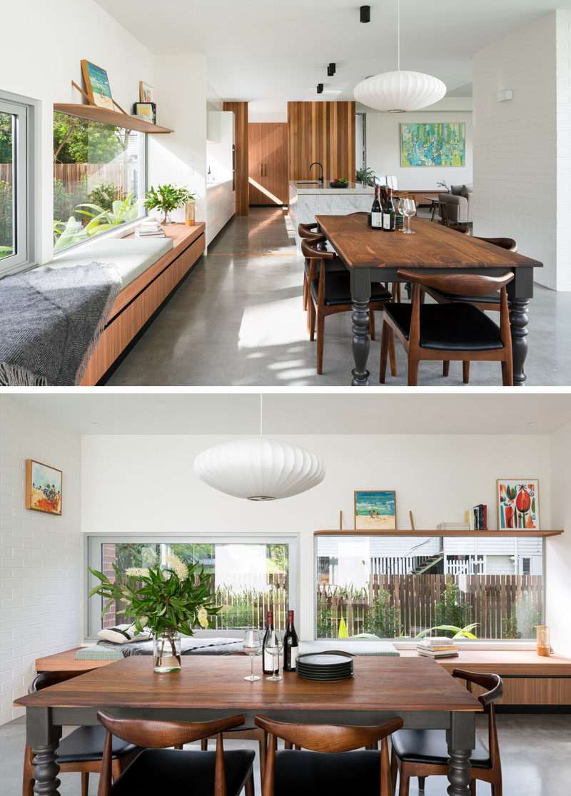 In this contemporary dining area, a long wood bench positioned beside the window creates a place to relax in the sunshine. #WindowBench #DiningRoom