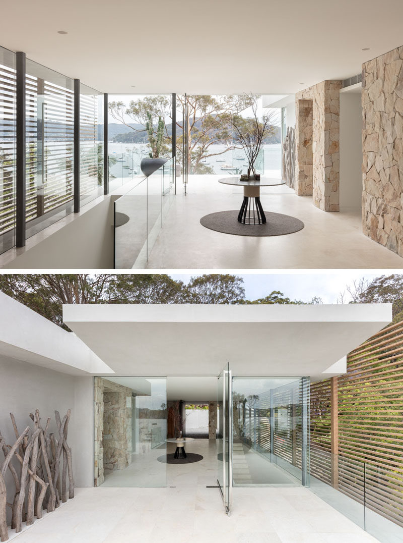 Stepping inside this modern waterfront house, the water views can be appreciated instantly through the floor-to-ceiling windows, while a glass door opens onto a balcony with almost invisible glass railings. #InteriorDesign #Windows #GlassRailings