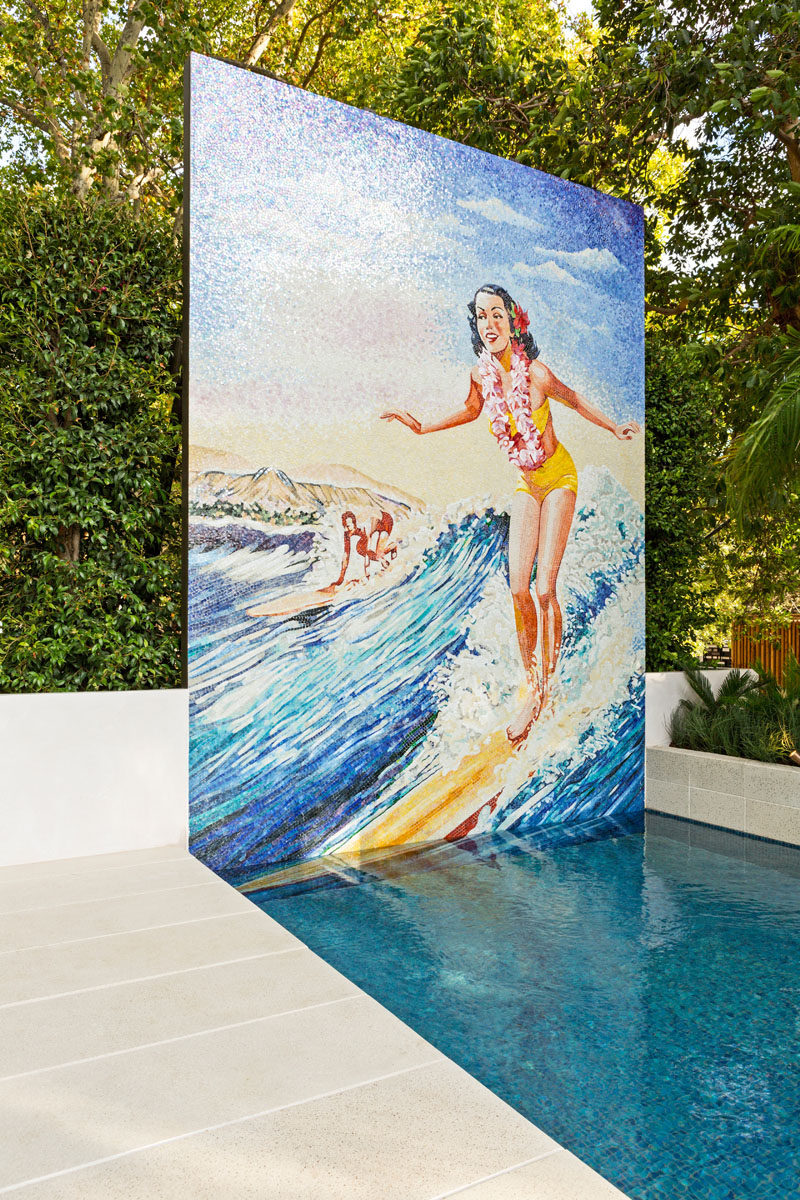 This modern pool features a hand-cut glass mosaic version of a classic Hawaiian surfer girls from the 1960s. #Mural #GlassMosaic #SwimmingPool