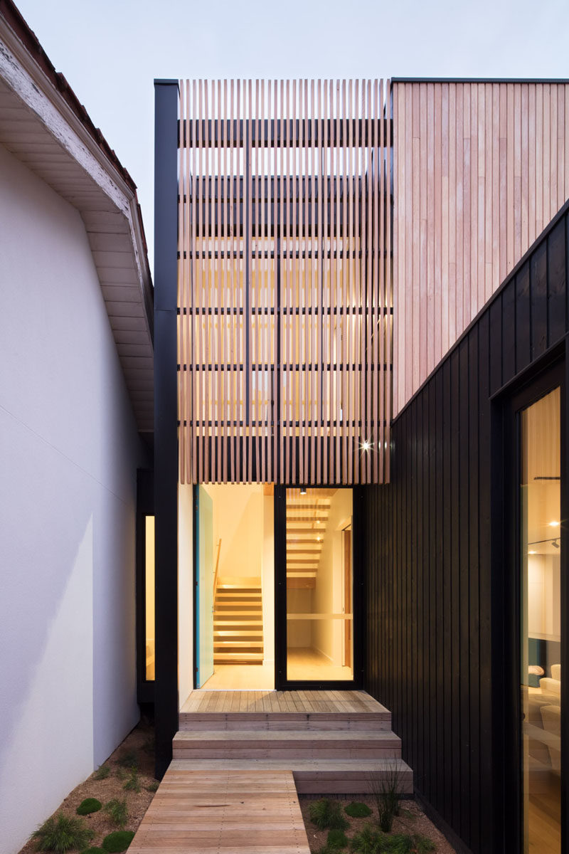 A new double-height entrance space has been created in the middle of this house providing a clean separation between the existing house and the new extension. #HouseExtension #Architecture