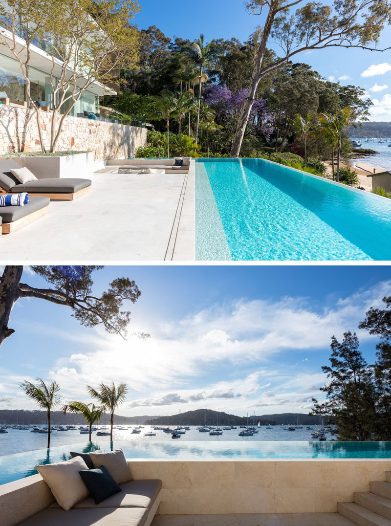 A long resort style infinity pool almost runs the entire width of this modern house house, while an adjacent sunken lounge and fire-pit create a place for relaxing. #SwimmingPool #SunkenLounge