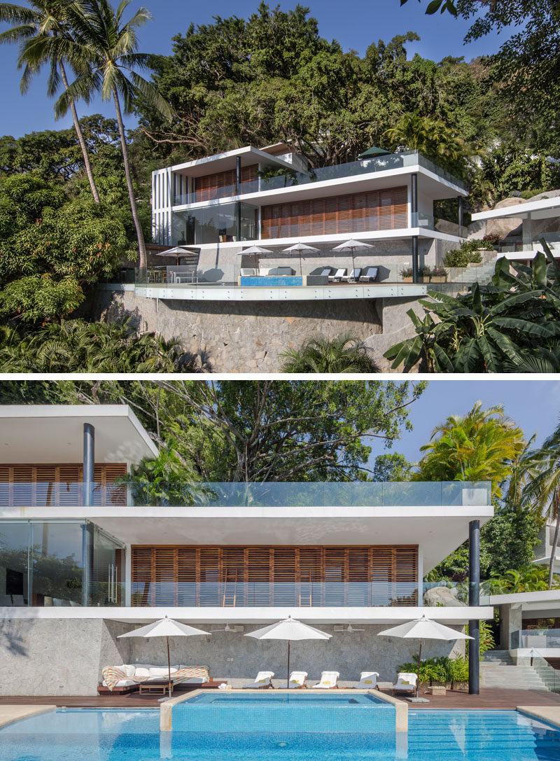 This modern house has a curved pool, wood shutters, and plenty of outdoor space for enjoying the views of the surrounding area. #ModernHouse #Architecture