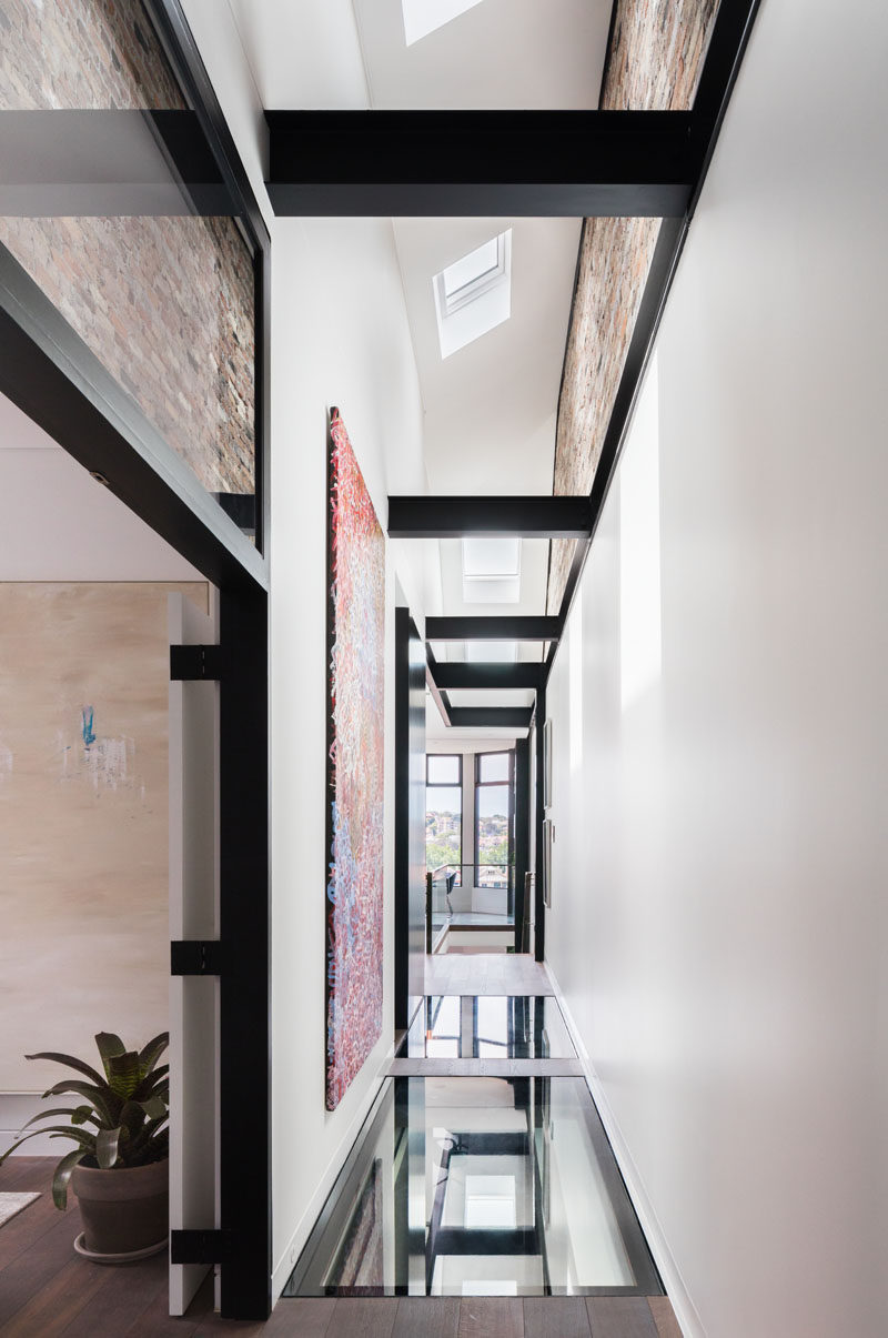 This modern house uses glass elements – skylights, glass flooring, highlight panels and balustrading – to create an open and bright interior. #GlassFloor #Skylights #ModernInterior