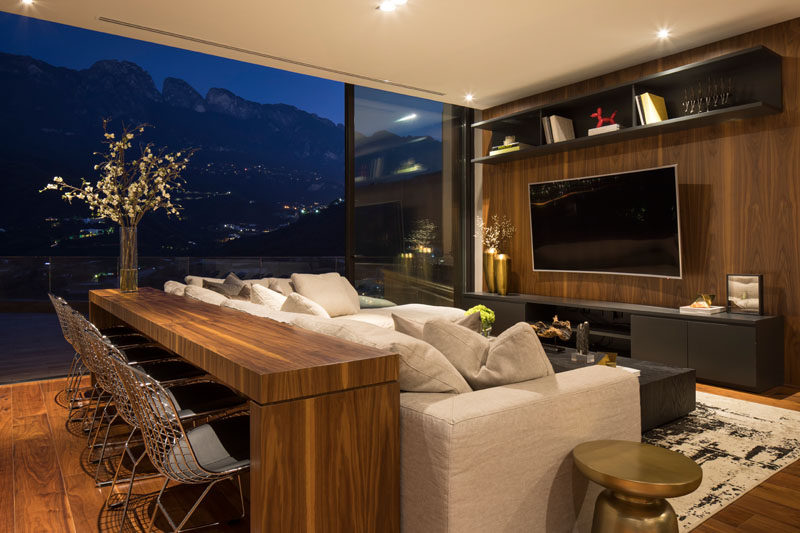 In this modern lounge area, a large sliding glass can open the space to the pool deck, however when closed off, the mountain views can still be admired. #LivingRoom #Lounge #InteriorDesign