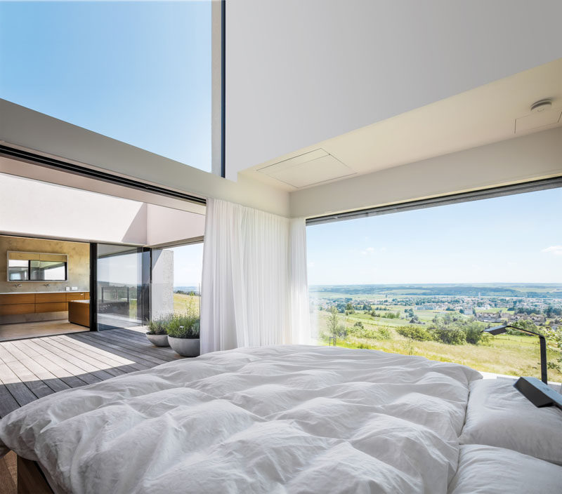 This modern master suite has the master bath and bedroom face and open up to a secluded open-air atrium. #MasterBedroom #MasterSuite #MasterBathroom #Archtiecture