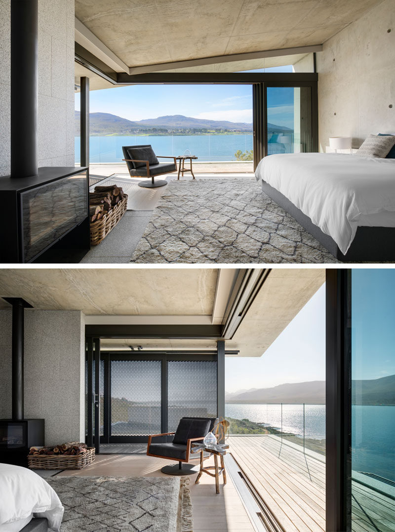 In this modern master bedroom suite, architectural materials such as concrete and granite have been used, while the bedroom is positioned to have elevated views across the lagoon and to the mountains beyond. #MasterBedroom #Fireplace #ModernBedroom