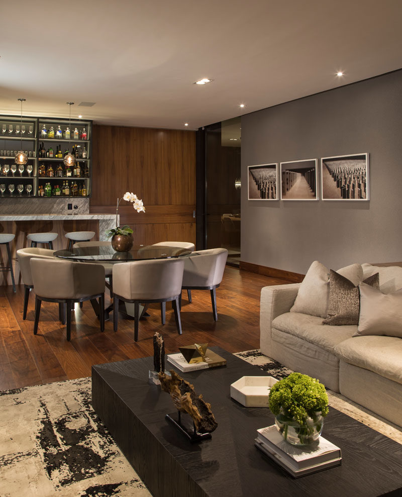 This modern house has a casual lounge and bar area with neutral tones and natural materials. #InteriorDesign #Bar #Dining #LivingRoom