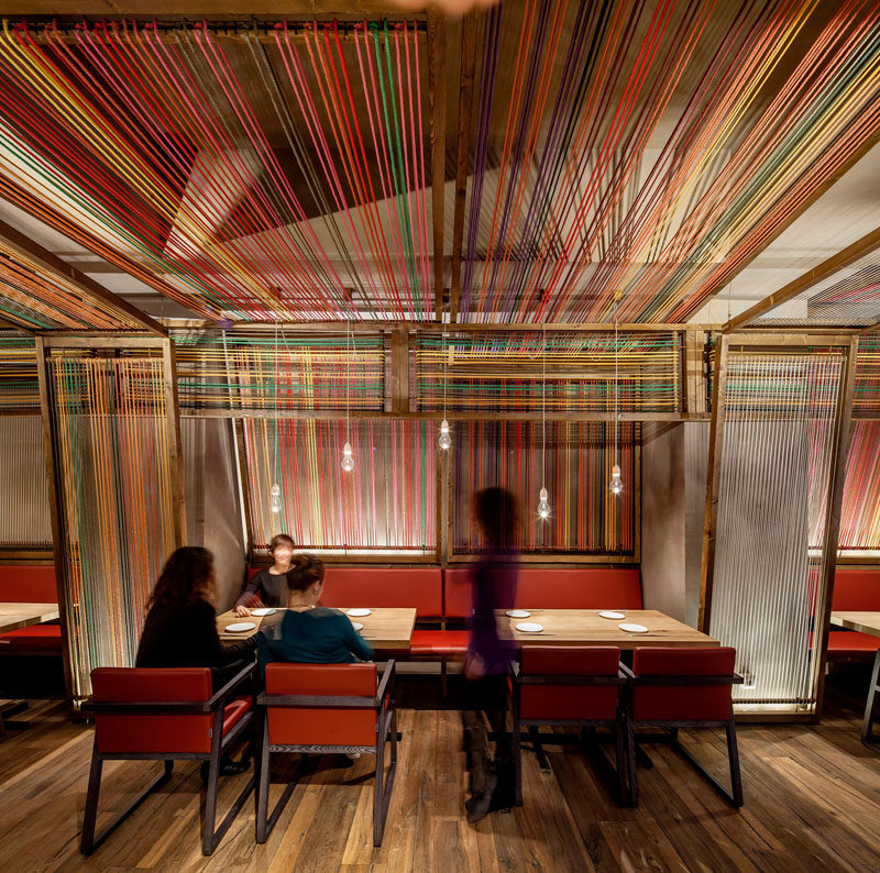 El Equipo Creativo have designed the Pakta Restaurant in Barcelona, Spain, that features an interior with brightly colored ropes. #InteriorDesign #RestaurantDesign #Rope #Ceiling