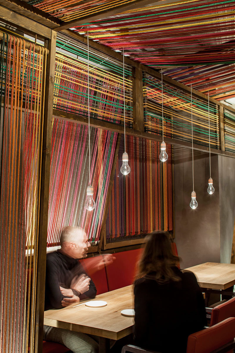 El Equipo Creativo have designed the Pakta Restaurant in Barcelona, Spain, that features an interior with brightly colored ropes. #InteriorDesign #RestaurantDesign #Rope #Ceiling