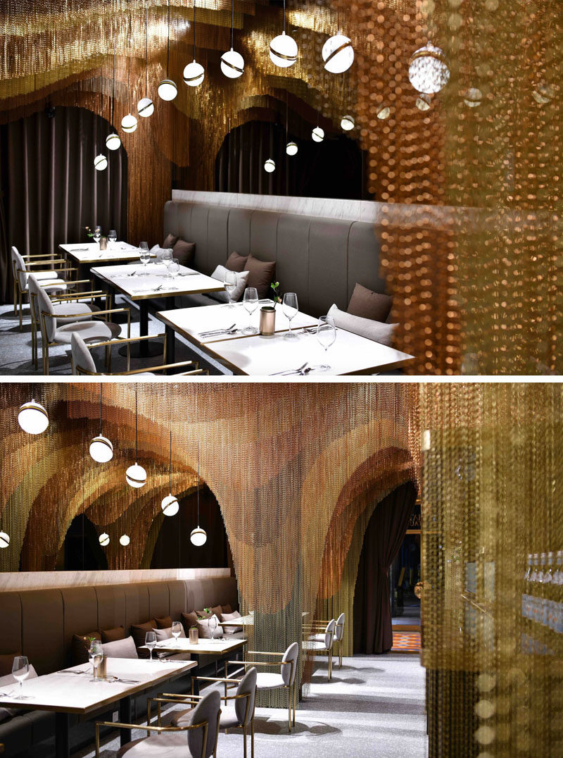 This modern restaurant features approximately 35,000 meters of gold chains that make up sculptural layers, mimicking the mountainous tea fields in China. #RestaurantDesign #ModernRestaurant #MetallicChains #InteriorDesign