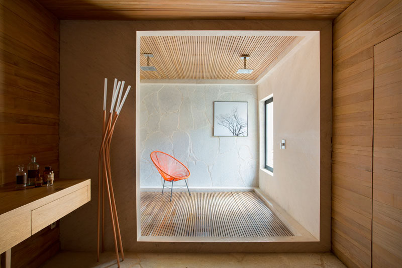 Wood features heavily in this modern bathroom that has a large open shower with two rainfall shower heads. #Bathroom #ModernBathroom #LargeShower #ShowerForTwo