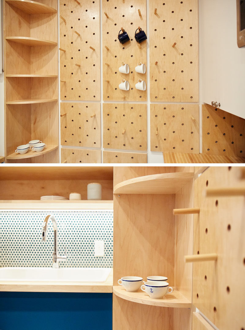 This small and modern kitchen has a custom pegboard wall, a tall curved corner shelf, and open shelves, to increase the storage the kitchen. #KitchenDesign #SmallKitchen #ModernKitchen #Pegboard #CornerShelf