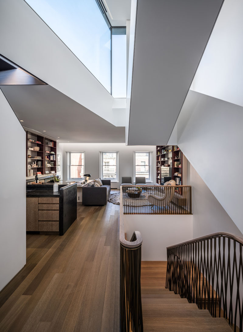 This modern house features a white oak floor throughout, and a home library provides a quiet place to relax. #HomeLibrary #WoodFloors #Windows