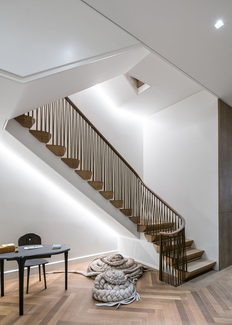 Sitting below these contemporary stairs with hidden lighting, is a sculpted writing desk and chair in ebonized ash by Christopher Kurtz, and floor knolls by Dana Barnes. #Stairs #Desk #Sculpture