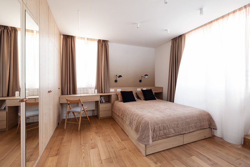 In this contemporary bedroom, the headboard runs along the wall and transforms into a desk. #Headboard #Bedroom