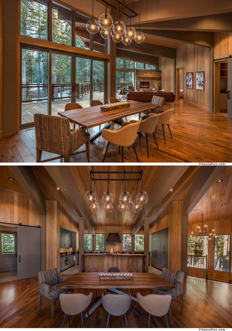 In this open plan interior, the wood dining table is positioned below a chandelier. #DiningRoom 