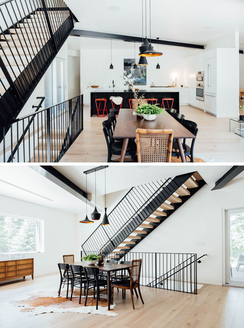 Lightly colored oak floors feature throughout this modern house, while the dining area, anchored in the open floor plan by three pendant lights, is located by the stairs. #ModernDining #DiningRoom #OpenFloorPlan #Stairs